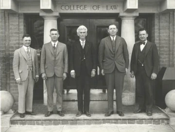 Group of Law Professors standing in front of Douglass Hall. Deans Fegtly and McCormick in the center. 